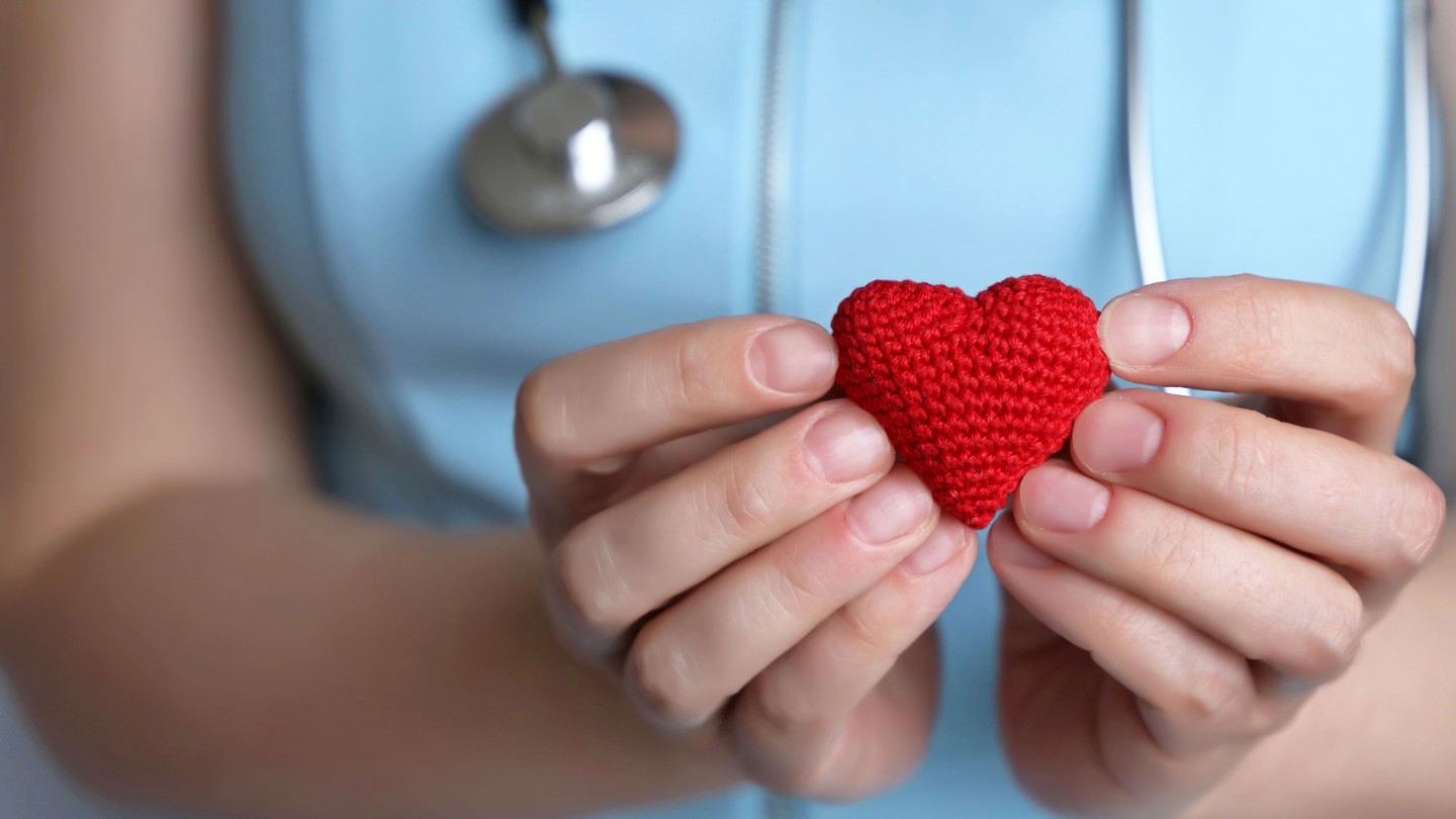 Hands holding a red heart