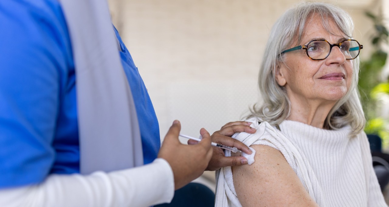 elderly woman getting a flu shot